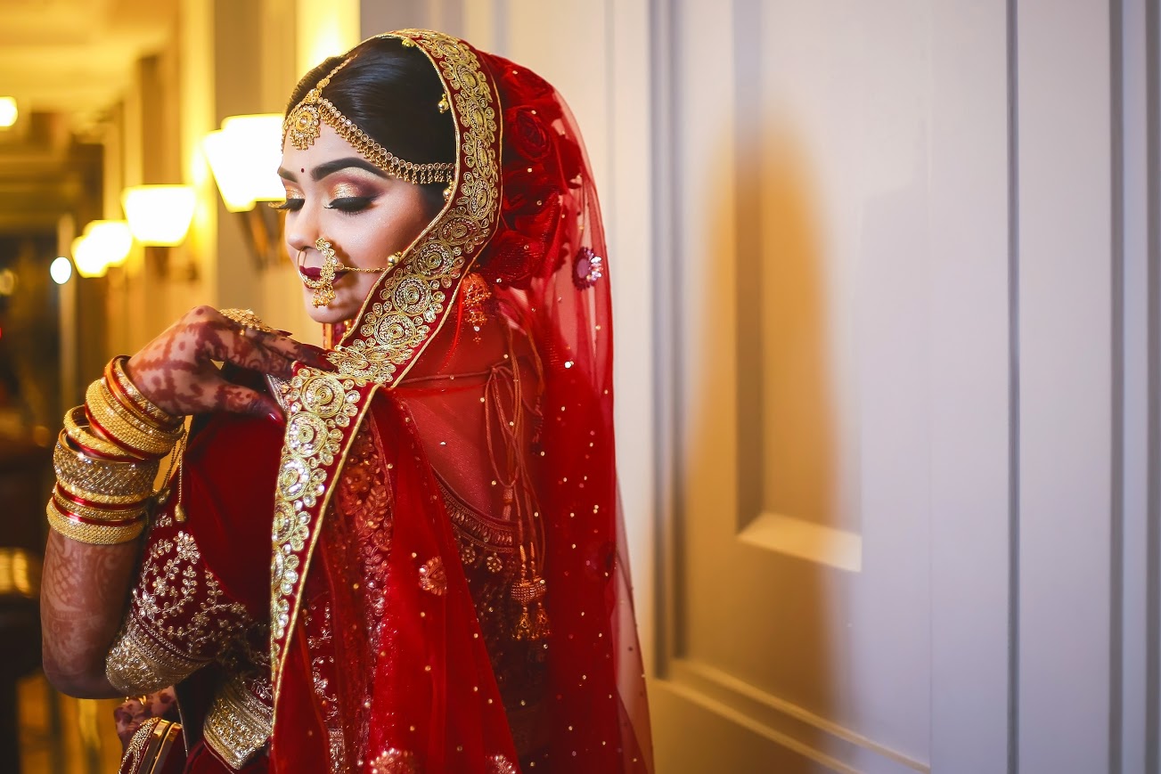 A person wearing an Indian bridal gown