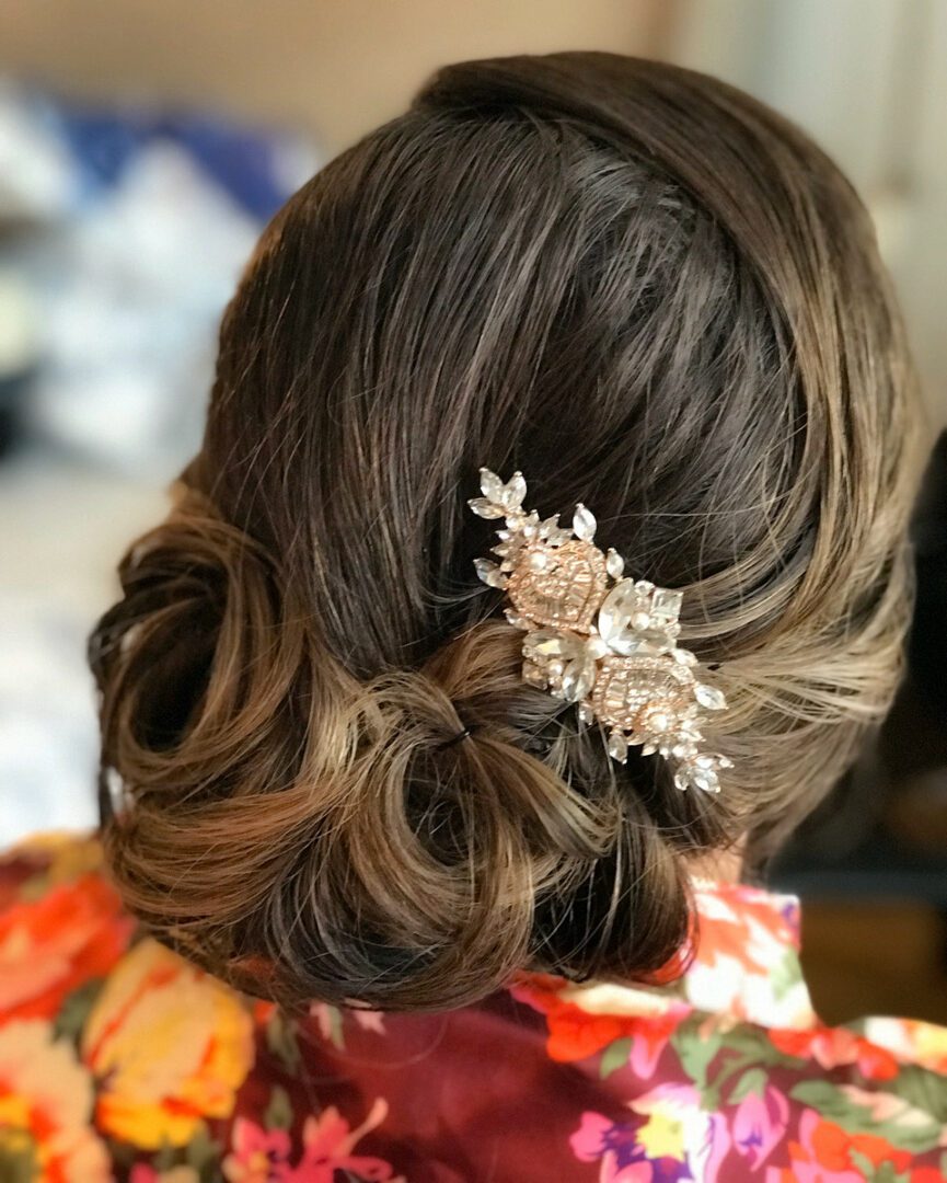 A woman with long hair and a decorative hairpiece.