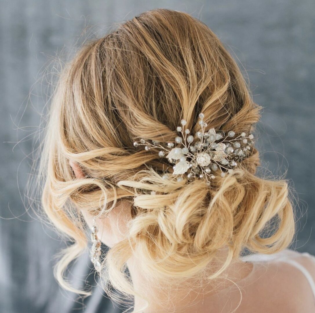 A woman with blonde hair and a decorative hairpiece.