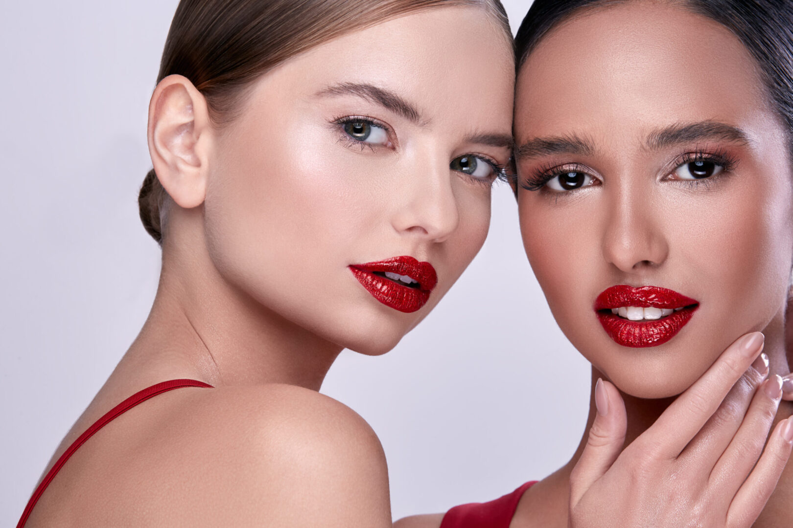 Two models wearing red lipstick