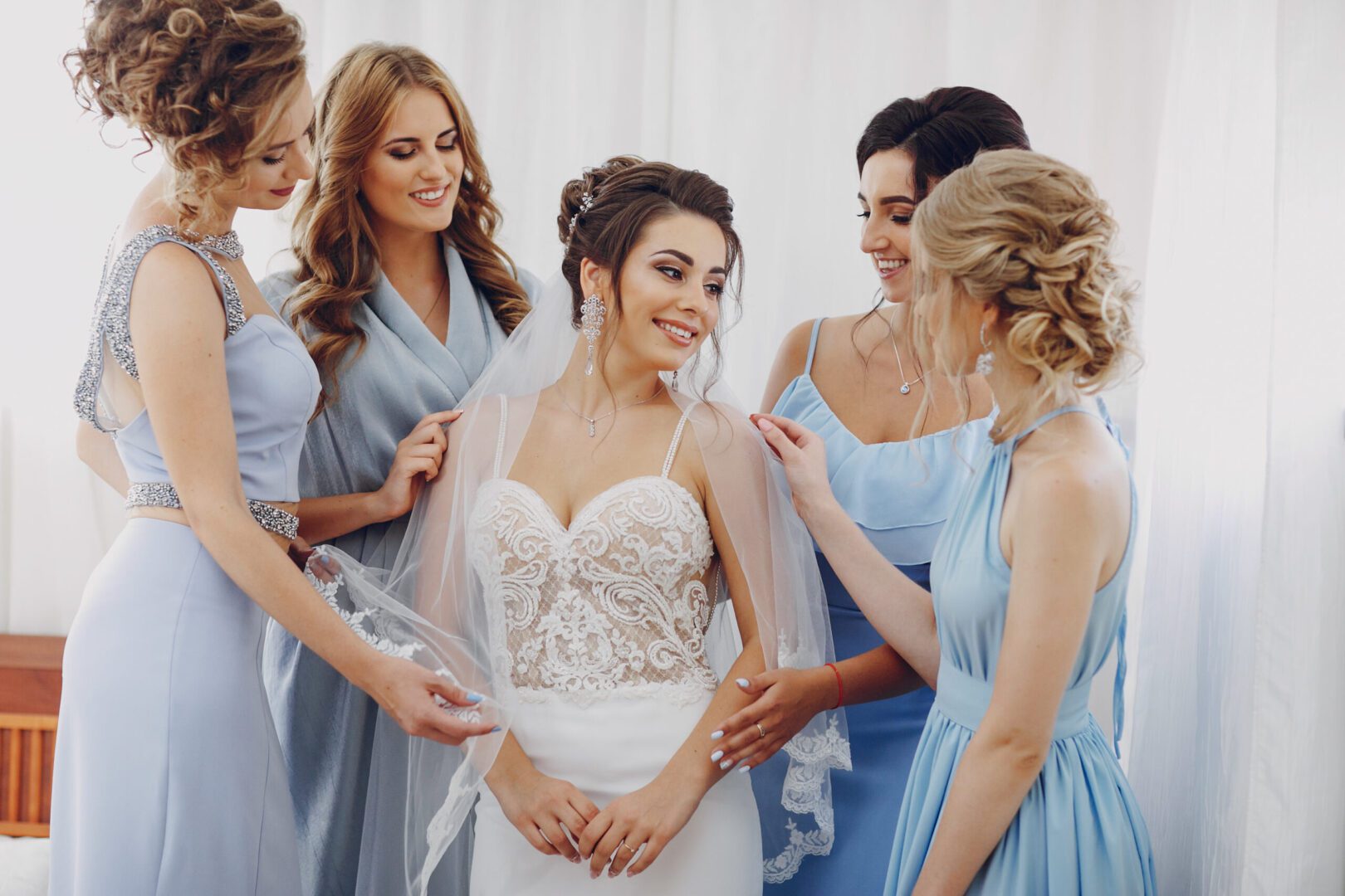 A bride surrounded by bridesmaids