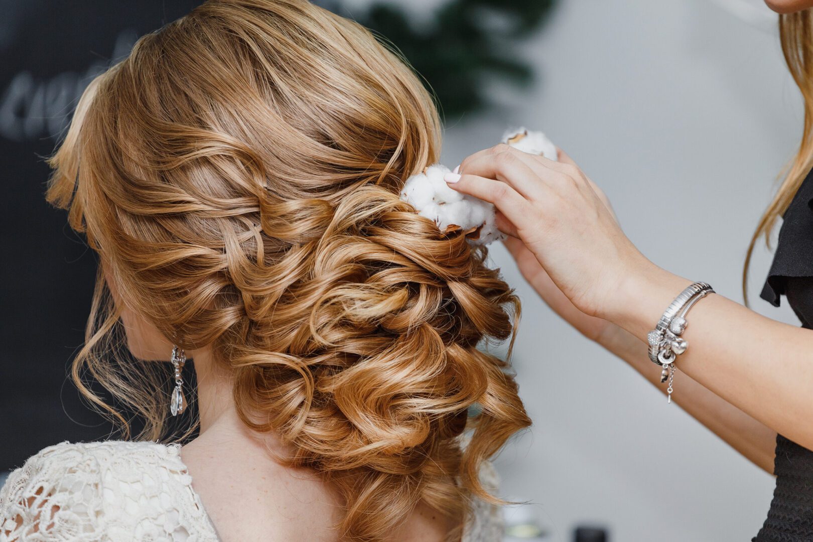 A person adding accessories to someone’s hair