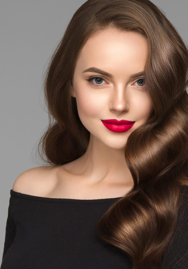 A woman with long hair and red lipstick.