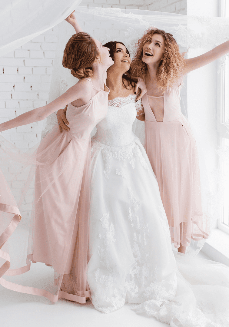 A group of women in pink dresses posing for the camera.